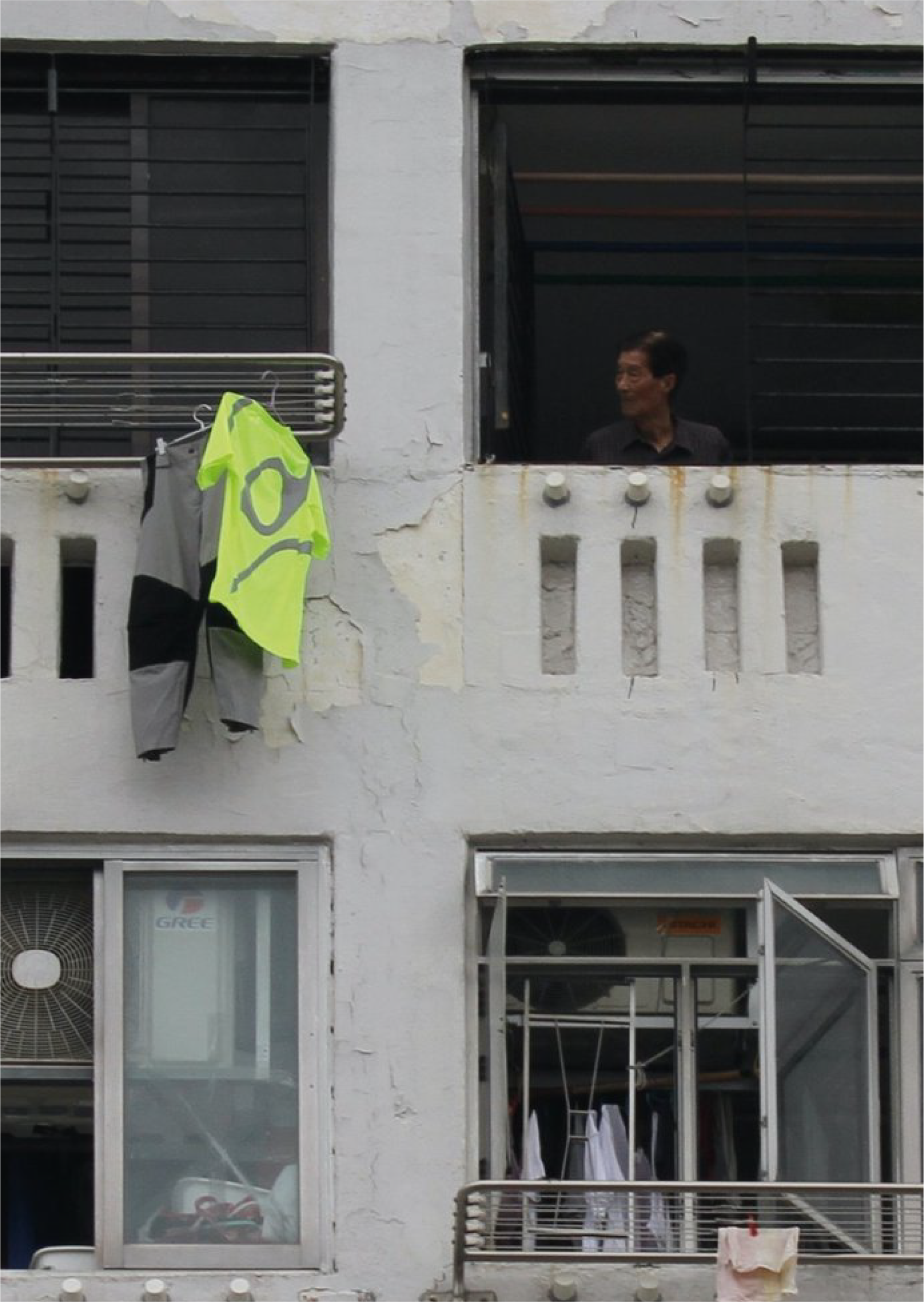 TMS.SITE press: Eye C Magazine wrote about TMS.SITE in 2022. Workwear shirt and pants hanging out a window in Hong Kong